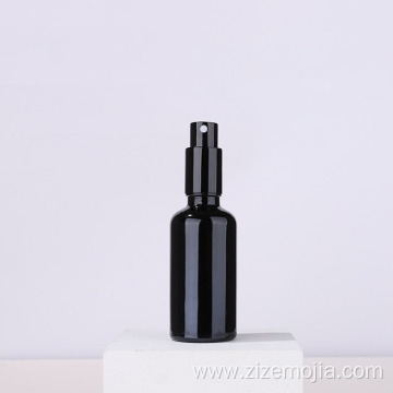 Empty black glass spray bottle with pump